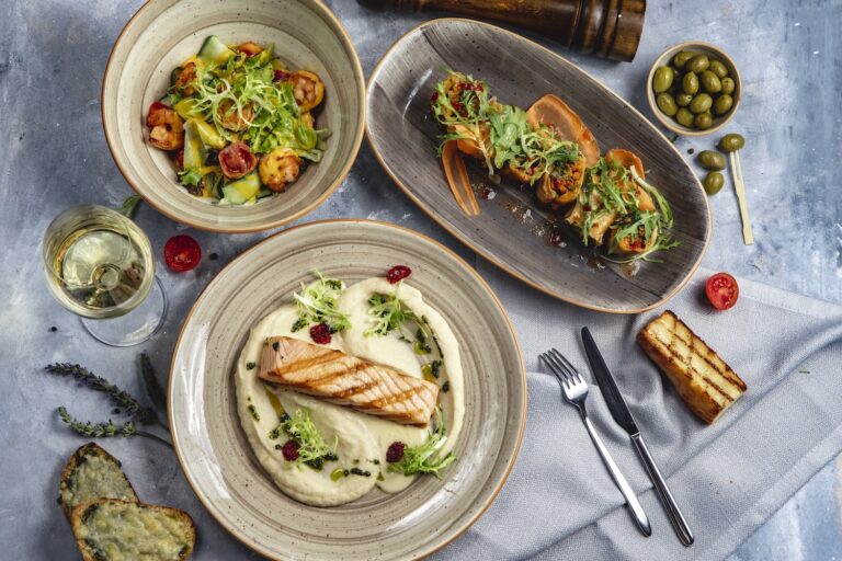 lunch set grilled salmon with mushed potato prawn salad vegetables roll white wine top view